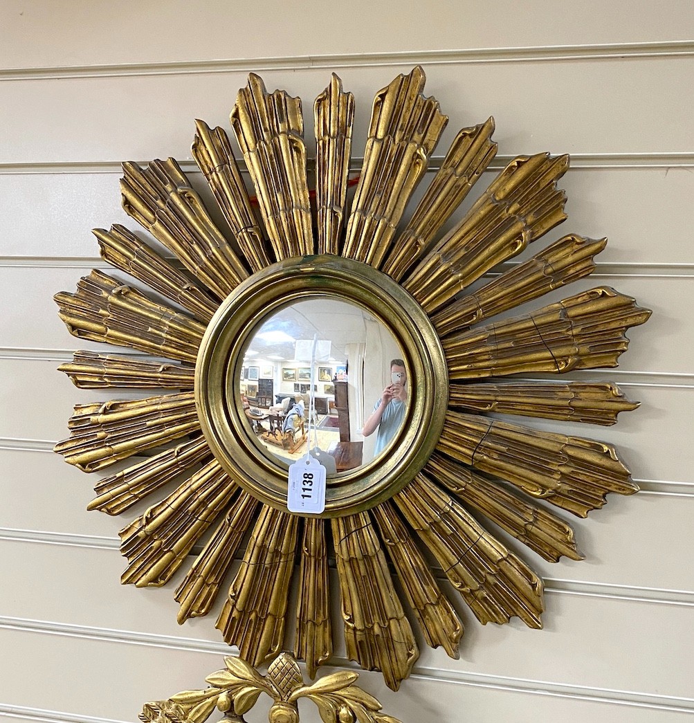 A gilt wood sunburst convex wall mirror, 64cm